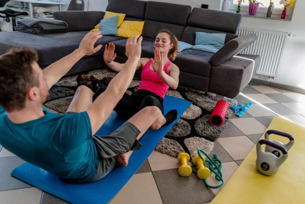 couple doing home workout on a budget in living room