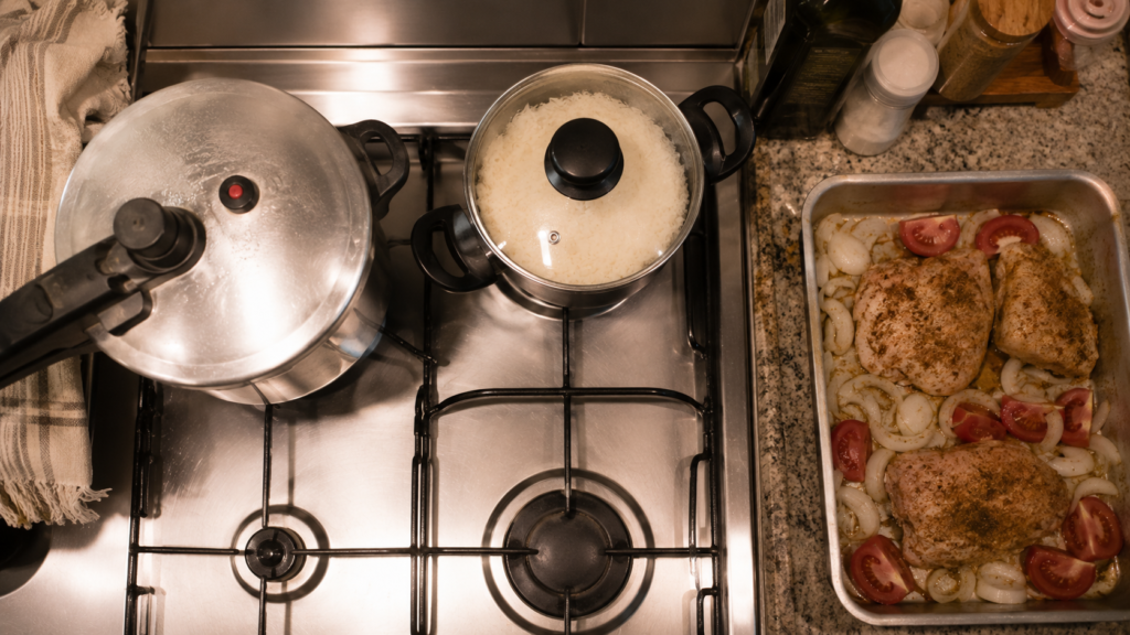 Pressure cooker, rice pot, and roasted chicken cooking in parallel — efficient cheap meal prep